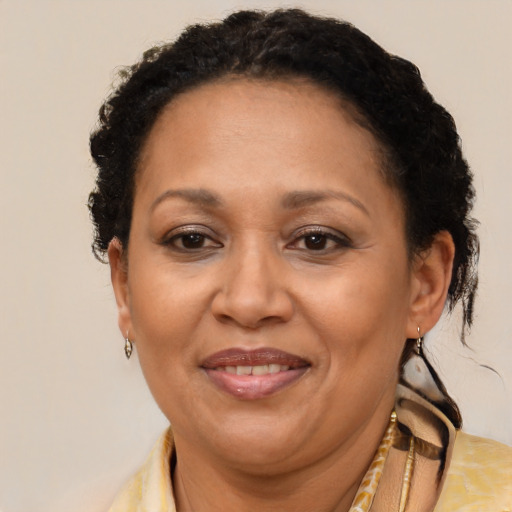 Joyful black adult female with short  brown hair and brown eyes