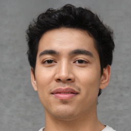 Joyful asian young-adult male with short  black hair and brown eyes