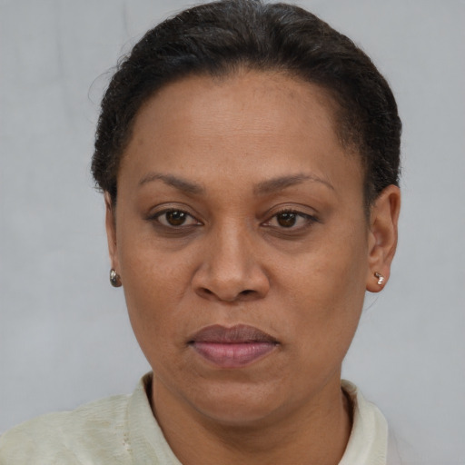 Joyful latino adult female with short  brown hair and brown eyes