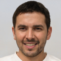 Joyful white young-adult male with short  brown hair and brown eyes