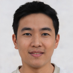 Joyful asian young-adult male with short  black hair and brown eyes