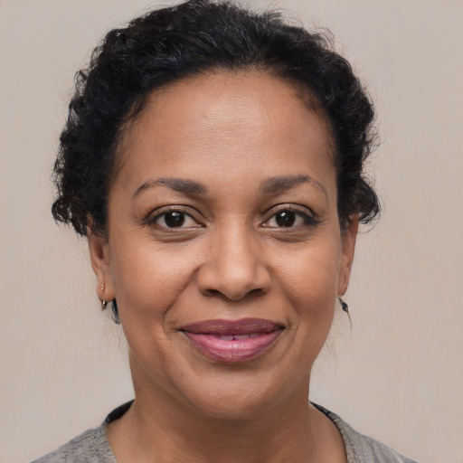 Joyful latino adult female with short  brown hair and brown eyes