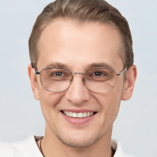 Joyful white adult male with short  brown hair and grey eyes