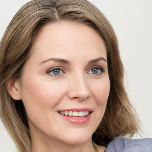 Joyful white young-adult female with long  brown hair and green eyes