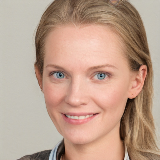 Joyful white young-adult female with long  brown hair and blue eyes