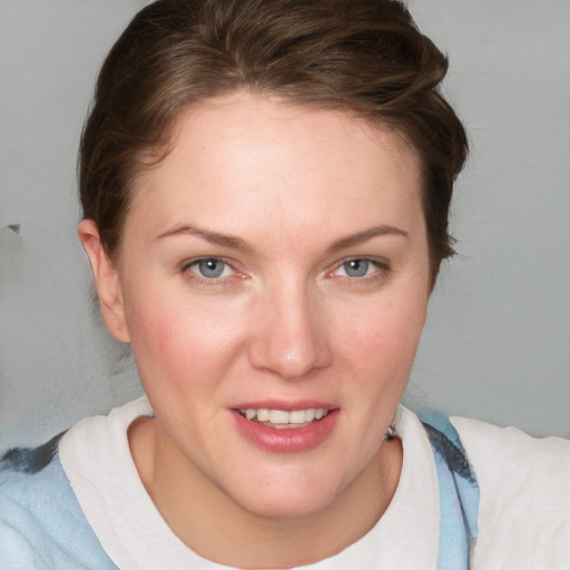 Joyful white young-adult female with medium  brown hair and blue eyes