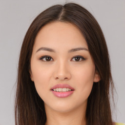 Joyful asian young-adult female with long  brown hair and brown eyes