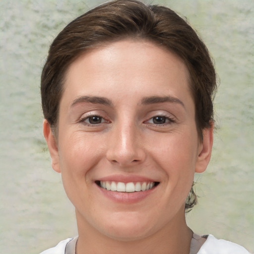 Joyful white young-adult female with short  brown hair and brown eyes