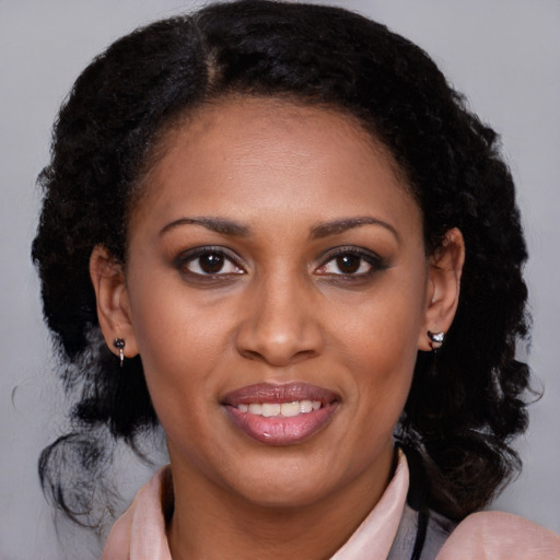 Joyful black young-adult female with medium  brown hair and brown eyes
