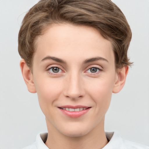 Joyful white young-adult female with short  brown hair and grey eyes