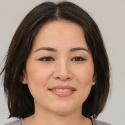 Joyful asian young-adult female with medium  brown hair and brown eyes