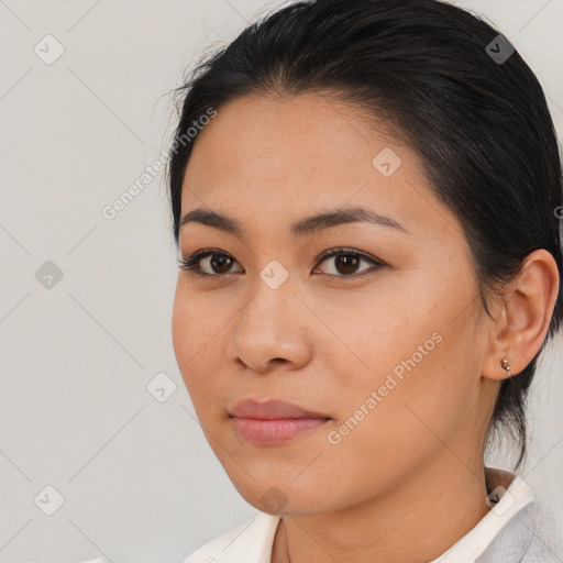 Joyful latino young-adult female with medium  brown hair and brown eyes