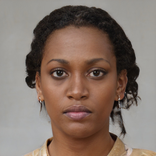 Neutral black young-adult female with medium  brown hair and brown eyes