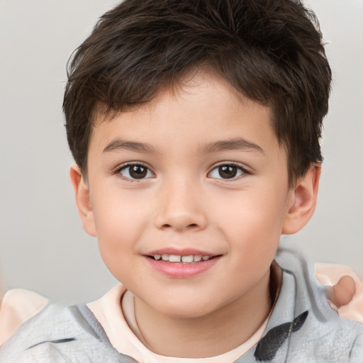 Joyful white child male with short  brown hair and brown eyes