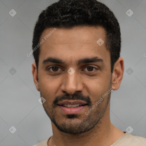 Joyful white young-adult male with short  black hair and brown eyes