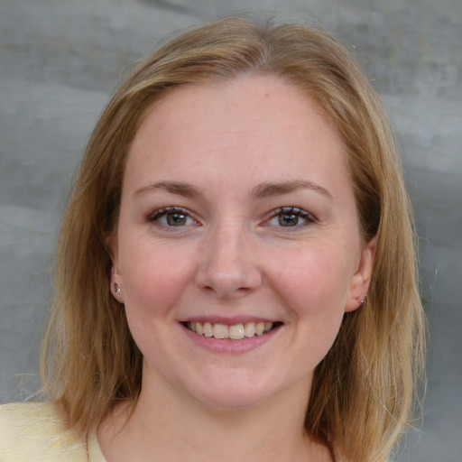 Joyful white young-adult female with medium  brown hair and blue eyes