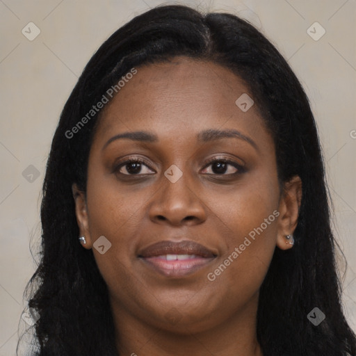 Joyful black young-adult female with long  brown hair and brown eyes