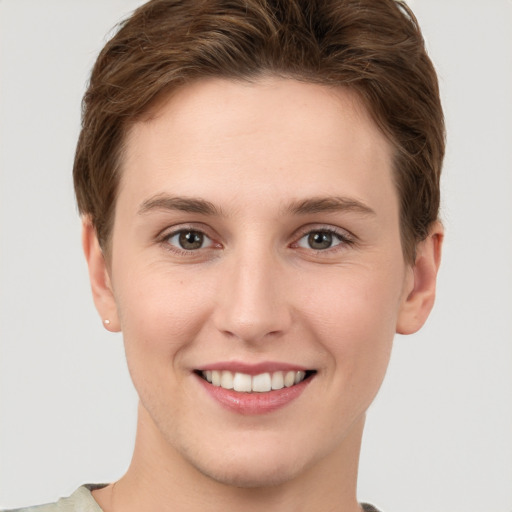 Joyful white young-adult female with short  brown hair and grey eyes