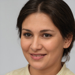 Joyful white adult female with medium  brown hair and brown eyes