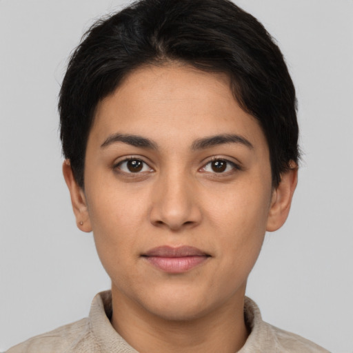 Joyful latino young-adult female with short  brown hair and brown eyes