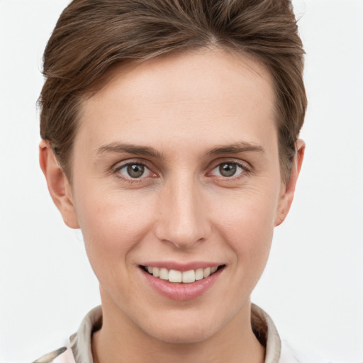 Joyful white young-adult female with short  brown hair and grey eyes