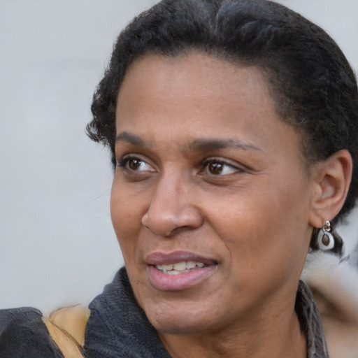 Joyful black adult female with short  black hair and brown eyes