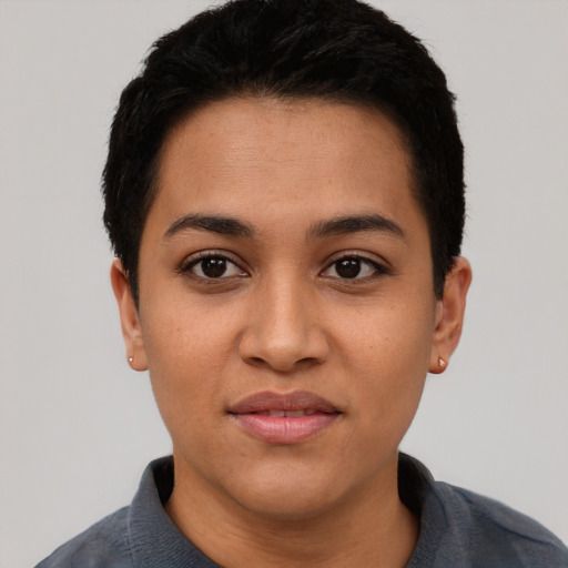 Joyful latino young-adult female with short  black hair and brown eyes