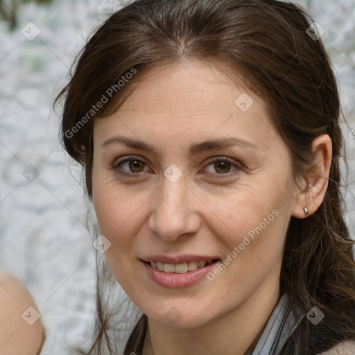 Joyful white adult female with long  brown hair and brown eyes