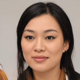 Joyful asian young-adult female with long  black hair and brown eyes