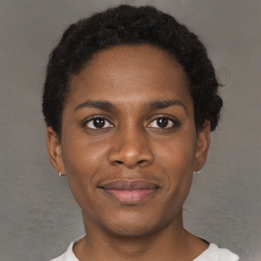 Joyful black young-adult female with short  black hair and brown eyes