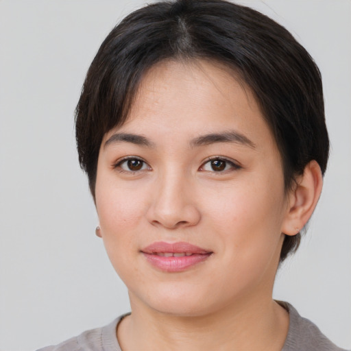 Joyful asian young-adult female with short  brown hair and brown eyes