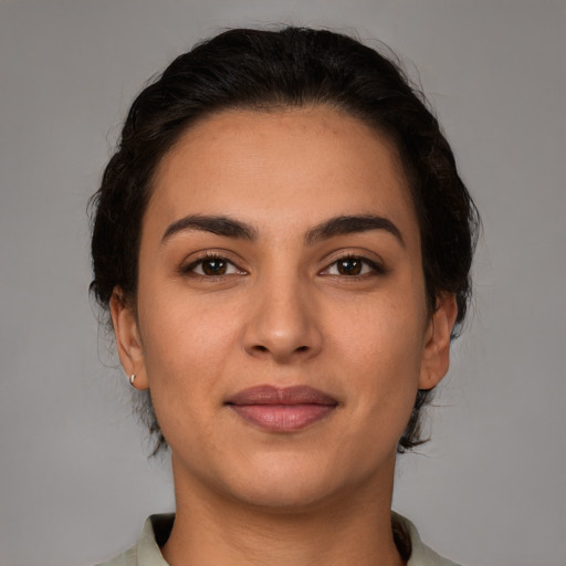 Joyful latino young-adult female with medium  brown hair and brown eyes