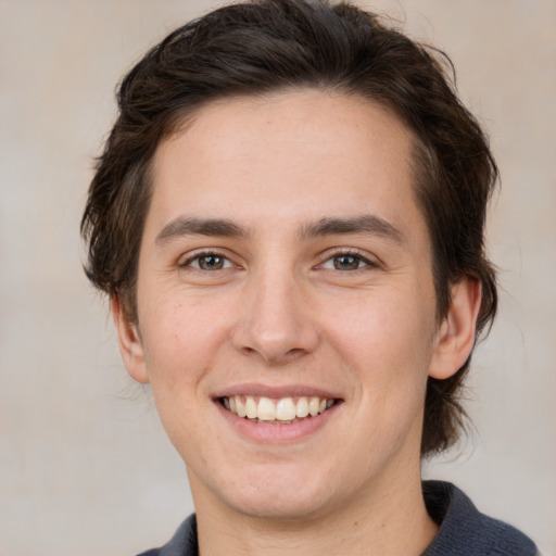 Joyful white young-adult male with medium  brown hair and brown eyes