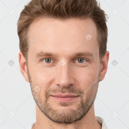 Joyful white adult male with short  brown hair and grey eyes