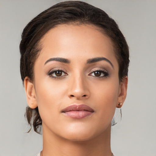 Joyful latino young-adult female with medium  brown hair and brown eyes