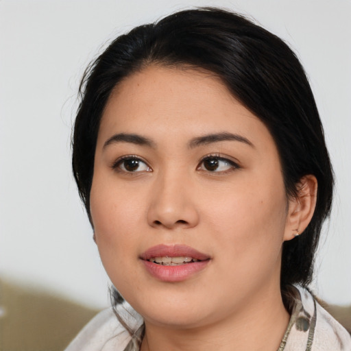 Joyful asian young-adult female with medium  black hair and brown eyes