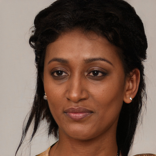 Joyful black young-adult female with medium  black hair and brown eyes