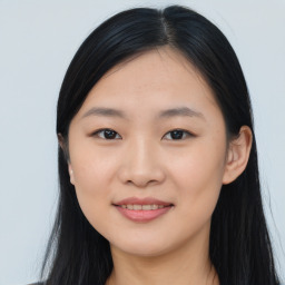 Joyful asian young-adult female with long  black hair and brown eyes