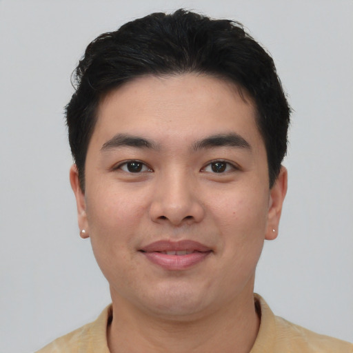 Joyful asian young-adult male with short  black hair and brown eyes