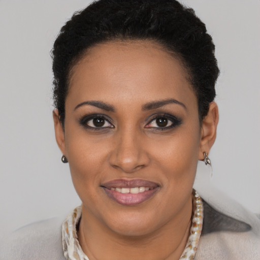 Joyful black young-adult female with short  brown hair and brown eyes