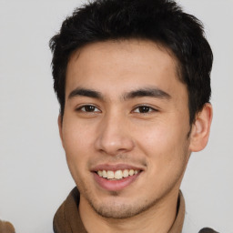 Joyful asian young-adult male with short  brown hair and brown eyes