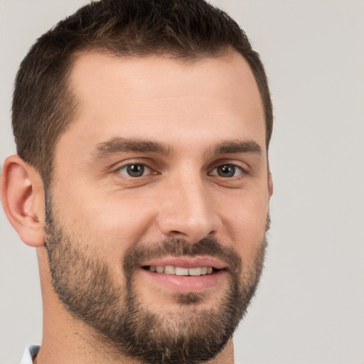 Joyful white young-adult male with short  brown hair and brown eyes