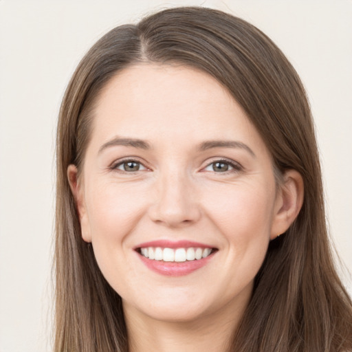 Joyful white young-adult female with long  brown hair and grey eyes