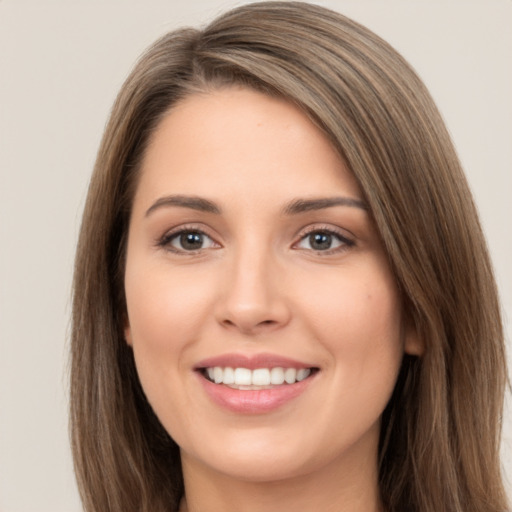 Joyful white young-adult female with long  brown hair and brown eyes