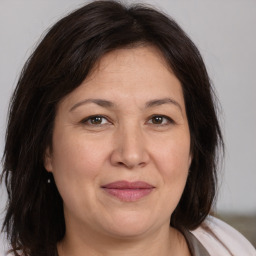 Joyful white adult female with medium  brown hair and brown eyes