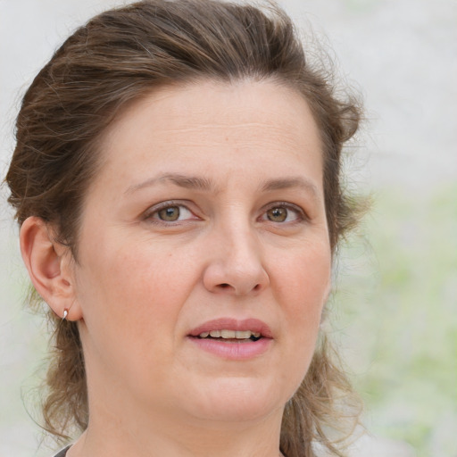 Joyful white adult female with medium  brown hair and grey eyes