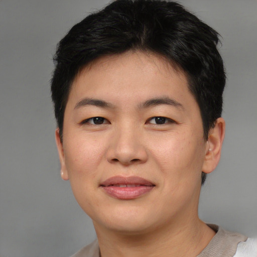 Joyful asian young-adult female with short  brown hair and brown eyes