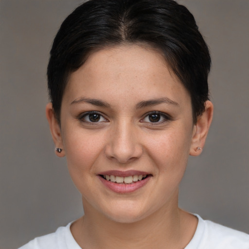 Joyful white young-adult female with short  brown hair and brown eyes