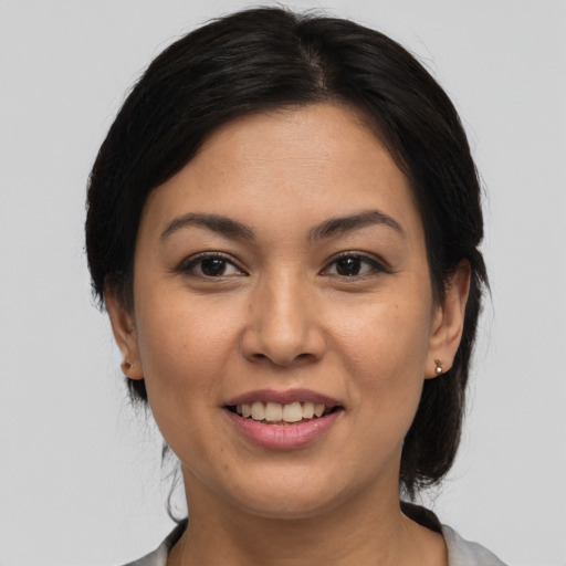 Joyful white young-adult female with medium  black hair and brown eyes