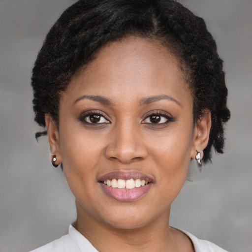 Joyful black young-adult female with short  brown hair and brown eyes